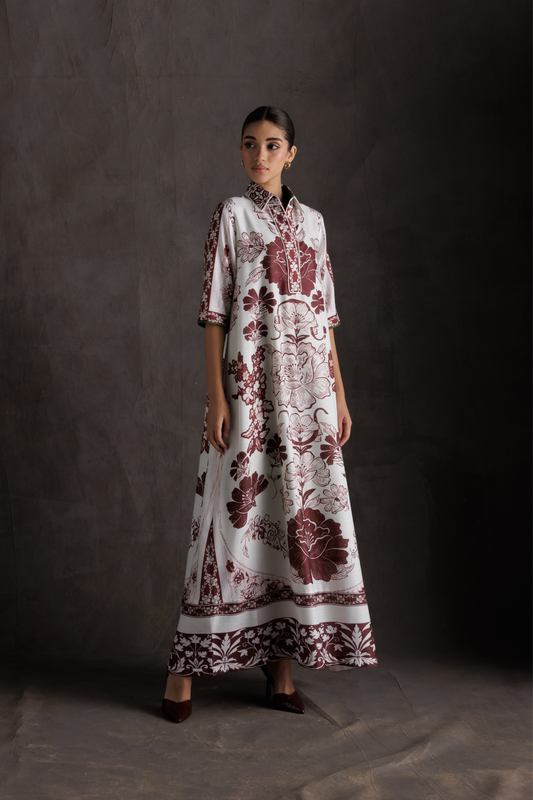 Woman wearing a floral dress against a dark background